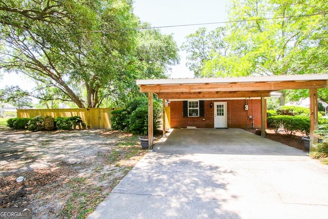 5034 W Ga Highway 292, Collins, GA 30421 - view of front of house featuring brick siding, fence, driveway, and a carport