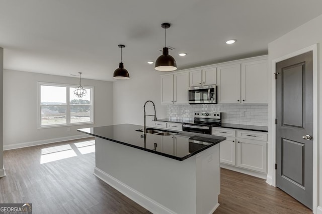 269 Franklin Hills Dr Unit B19, Carnesville, GA 30521 - kitchen featuring appliances with stainless steel finishes, dark countertops, tasteful backsplash, dark wood-style flooring, and recessed lighting