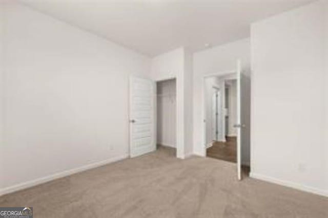 1406 Adirondac Way, Bonaire, GA 31005 - unfurnished bedroom featuring baseboards, carpet flooring, and a closet