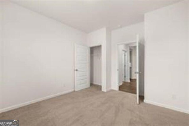 1406 Adirondac Way, Bonaire, GA 31005 - unfurnished bedroom with carpet floors, baseboards, and a closet