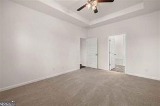1406 Adirondac Way, Bonaire, GA 31005 - unfurnished bedroom featuring ceiling fan, ensuite bath, carpet, baseboards, and a tray ceiling