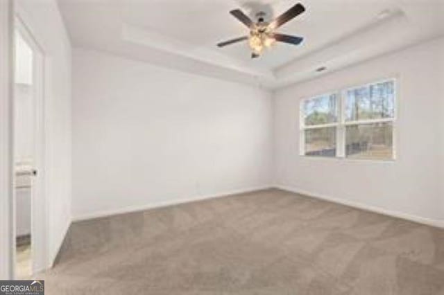 1406 Adirondac Way, Bonaire, GA 31005 - carpeted empty room featuring baseboards, ceiling fan, and a tray ceiling