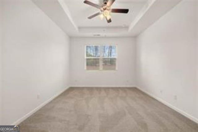 1406 Adirondac Way, Bonaire, GA 31005 - carpeted spare room with baseboards, a ceiling fan, and a tray ceiling