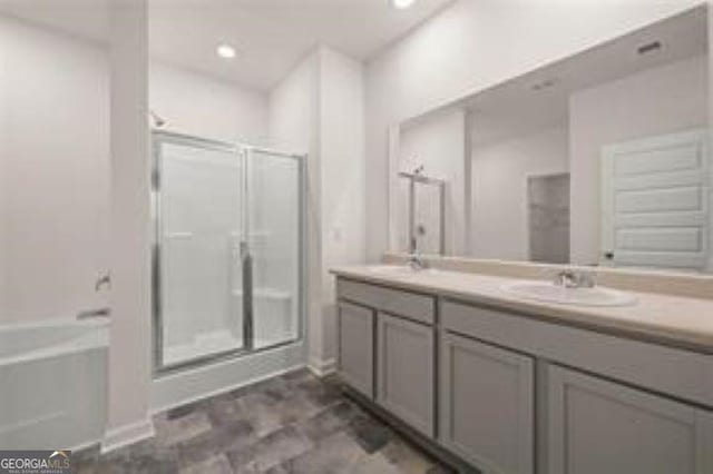 1406 Adirondac Way, Bonaire, GA 31005 - bathroom featuring a sink, double vanity, baseboards, a shower stall, and a garden tub