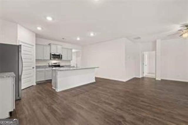1406 Adirondac Way, Bonaire, GA 31005 - kitchen featuring appliances with stainless steel finishes, a center island with sink, dark wood-style floors, open floor plan, and recessed lighting