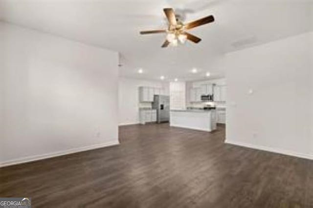 1406 Adirondac Way, Bonaire, GA 31005 - unfurnished living room with ceiling fan, dark wood finished floors, and baseboards