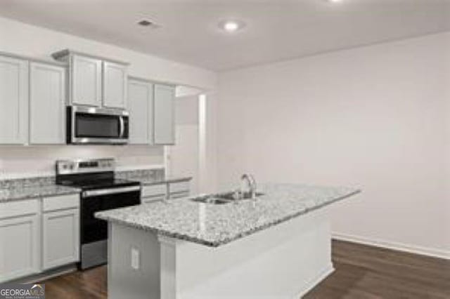 1406 Adirondac Way, Bonaire, GA 31005 - kitchen with dark wood-type flooring, a sink, a kitchen island with sink, and stainless steel appliances