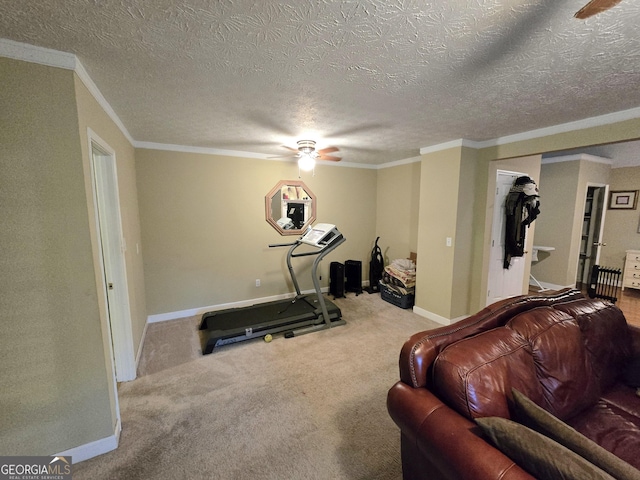 workout room featuring a ceiling fan, a textured ceiling, crown molding, baseboards, and carpet flooring