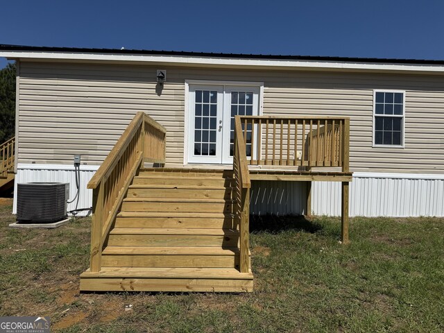 rear view of property with central air condition unit, french doors, stairs, and a wooden deck