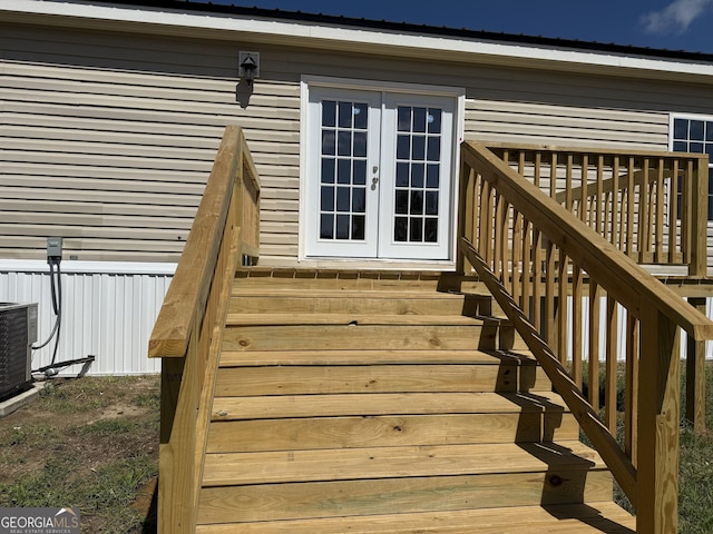 deck with french doors, stairs, and central AC