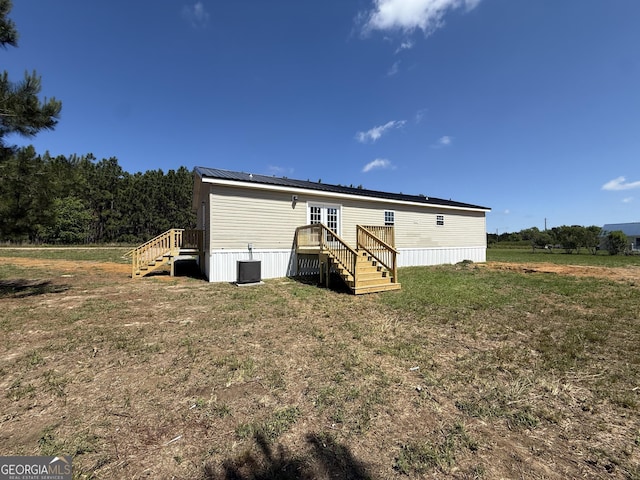 back of house with cooling unit, a yard, stairway, and a deck