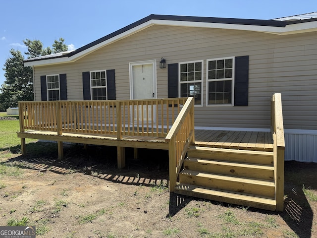 back of property featuring a wooden deck
