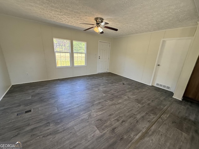 unfurnished room with dark wood-style flooring, a textured ceiling, visible vents, and ceiling fan