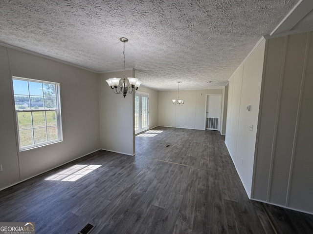 unfurnished dining area featuring visible vents, ornamental molding, dark wood-style flooring, a textured ceiling, and a notable chandelier