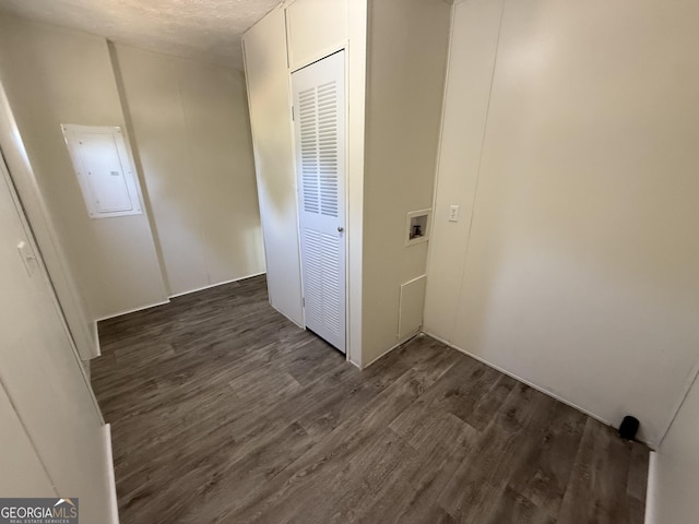 clothes washing area featuring dark wood-style flooring, washer hookup, and electric panel