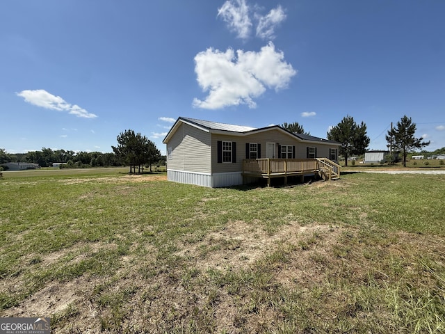 exterior space featuring a lawn and a wooden deck