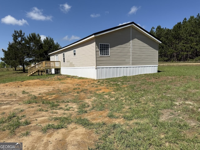 view of property exterior with a wooden deck