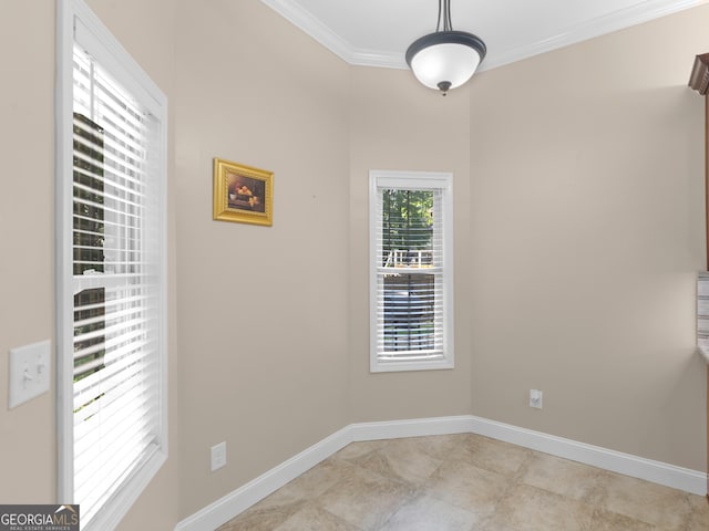 unfurnished dining area with crown molding and baseboards