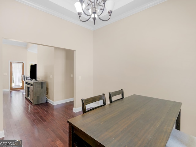 dining area with crown molding, baseboards, a notable chandelier, and dark wood finished floors