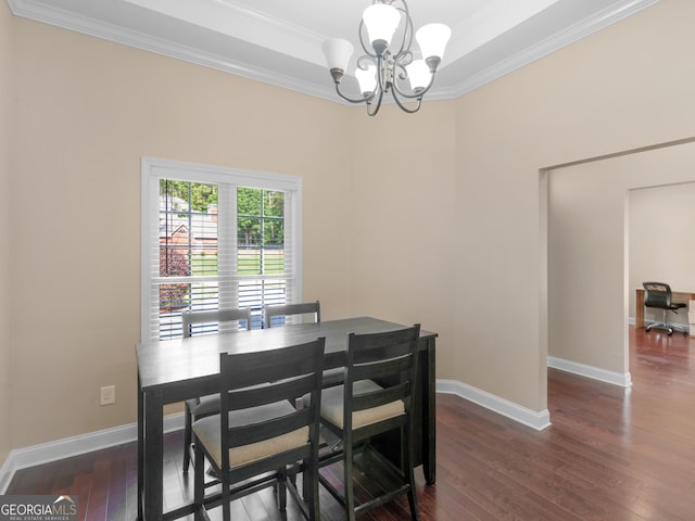 dining space with baseboards, ornamental molding, dark wood finished floors, and a notable chandelier