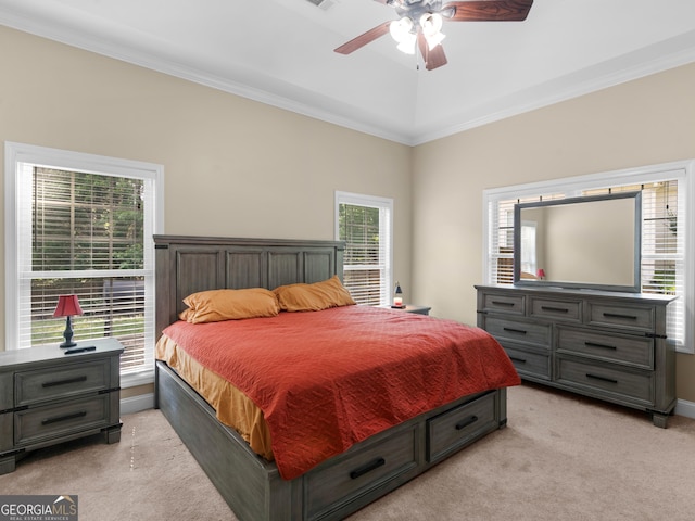 bedroom with crown molding, a ceiling fan, baseboards, and light carpet