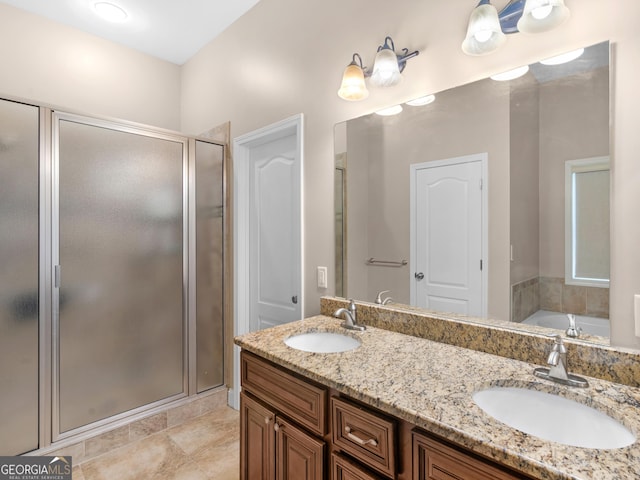 full bathroom with double vanity, a shower stall, a sink, and a garden tub