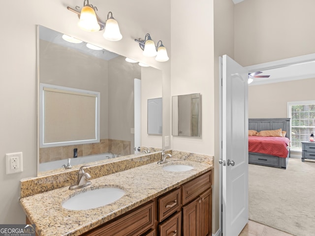 full bath with double vanity, tile patterned flooring, a sink, and ensuite bathroom