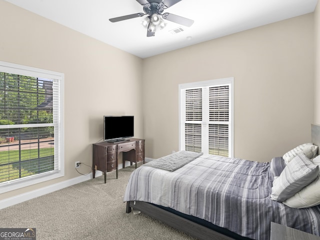 bedroom with baseboards, ceiling fan, carpet, and visible vents