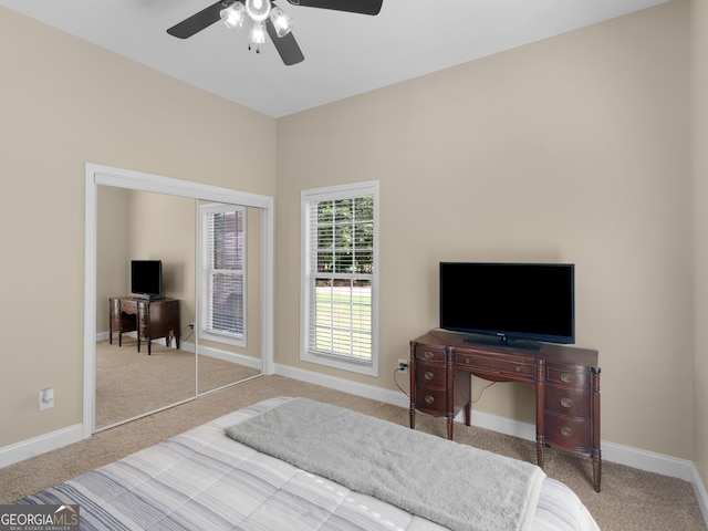 carpeted bedroom featuring baseboards and a ceiling fan