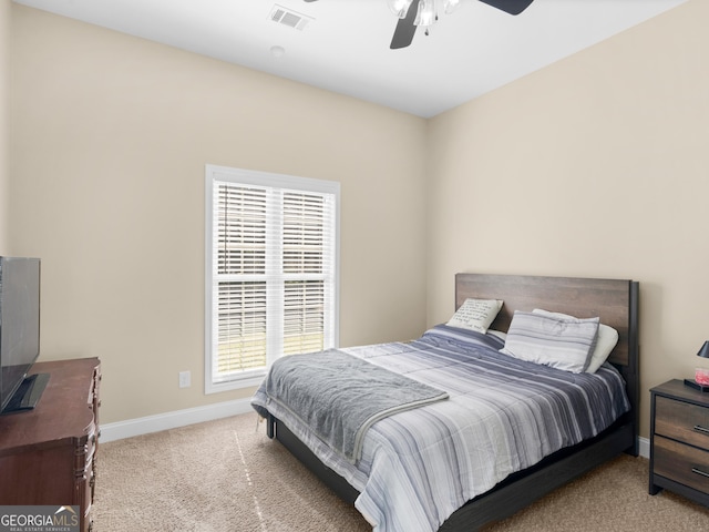 carpeted bedroom featuring visible vents, baseboards, and ceiling fan