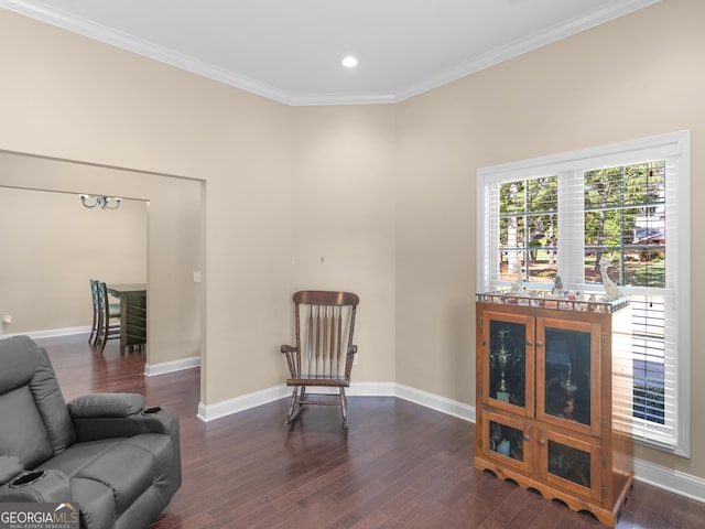 sitting room featuring dark wood-style flooring, baseboards, recessed lighting, and ornamental molding