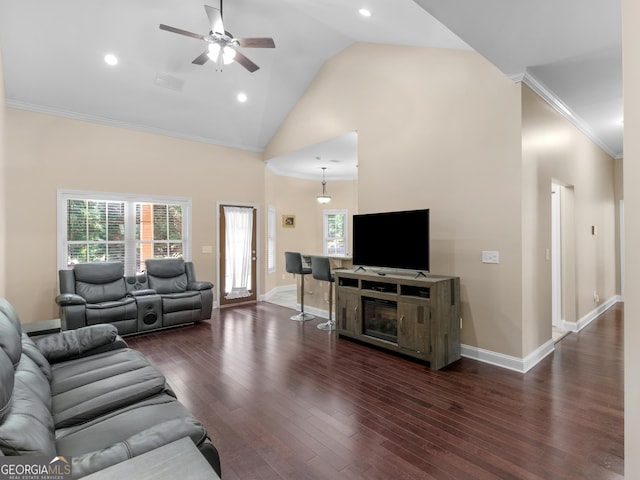 living room with crown molding, ceiling fan, plenty of natural light, and wood finished floors