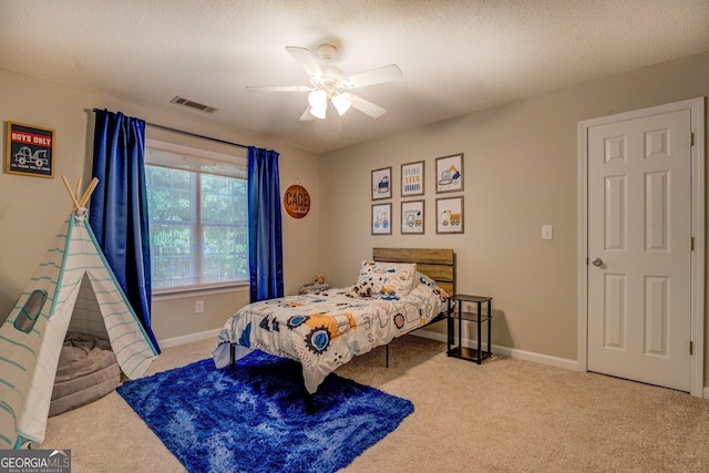 carpeted bedroom featuring baseboards and a ceiling fan