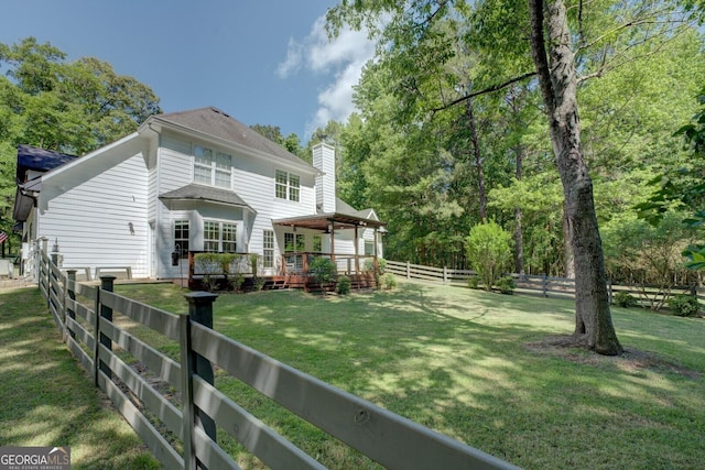857 Cooper Rd, Social Circle, GA 30025 - back of property featuring a wooden deck, a fenced backyard, and a chimney