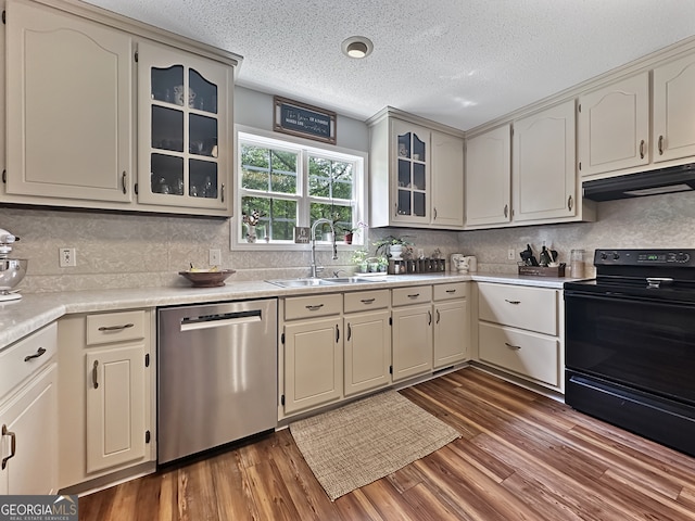 kitchen featuring dark wood-style flooring, a sink, dishwasher, black range with electric cooktop, and under cabinet range hood