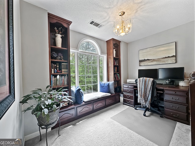 office area featuring visible vents, a textured ceiling, a chandelier, and light colored carpet