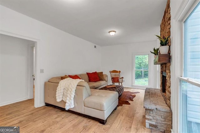 143 Navajo Trl, Rydal, GA 30171 - living area with wood finished floors, a stone fireplace, and baseboards