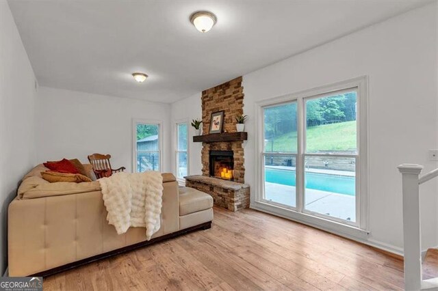 143 Navajo Trl, Rydal, GA 30171 - living area featuring plenty of natural light, light wood-type flooring, and a stone fireplace