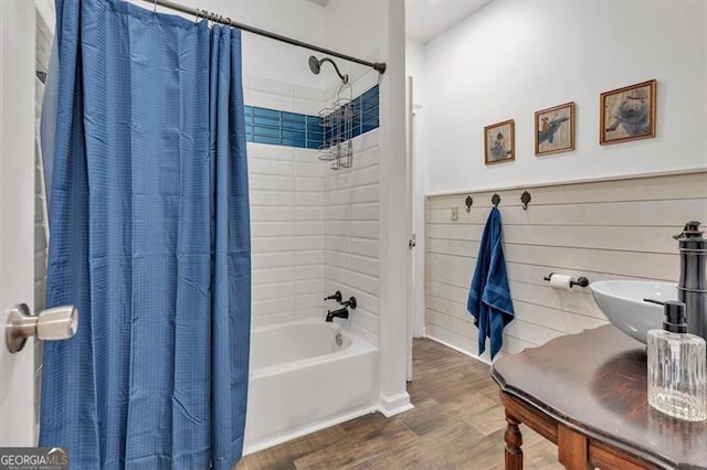 143 Navajo Trl, Rydal, GA 30171 - full bathroom with wood finished floors, shower / tub combo, a sink, and a wainscoted wall