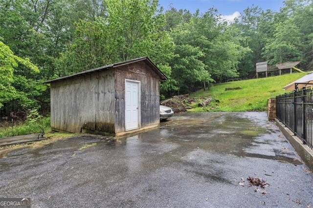 143 Navajo Trl, Rydal, GA 30171 - view of shed with fence and a view of trees