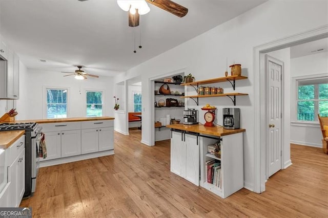 143 Navajo Trl, Rydal, GA 30171 - kitchen featuring a ceiling fan, stainless steel range with gas stovetop, open shelves, wooden counters, and light wood finished floors