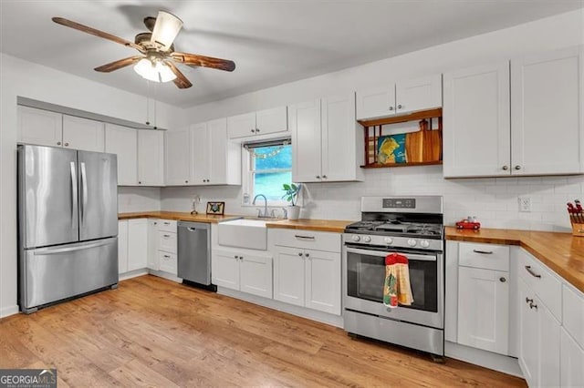 143 Navajo Trl, Rydal, GA 30171 - kitchen featuring stainless steel appliances, a sink, wood counters, a ceiling fan, and tasteful backsplash
