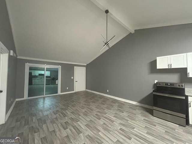 interior space with baseboards, vaulted ceiling with beams, and light wood finished floors