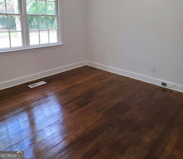 2074 Melton Ave, Macon, GA 31217 - empty room featuring baseboards and dark wood-type flooring