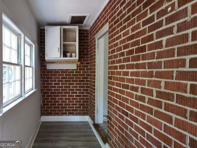 2074 Melton Ave, Macon, GA 31217 - hallway with baseboards, brick wall, and dark wood-style floors