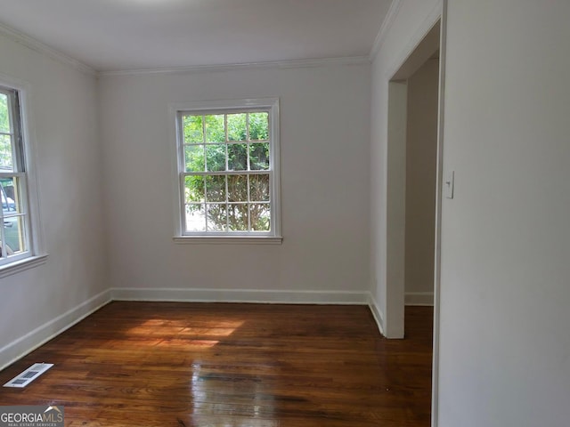 2074 Melton Ave, Macon, GA 31217 - empty room with healthy amount of natural light, dark wood-style floors, ornamental molding, and baseboards
