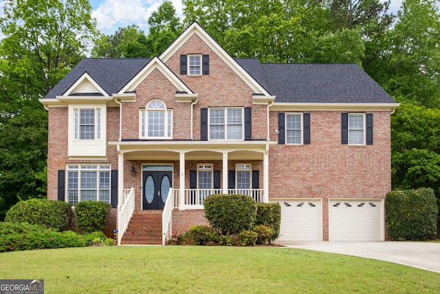 view of front of house featuring a front yard, brick siding, concrete driveway, an attached garage, and a porch