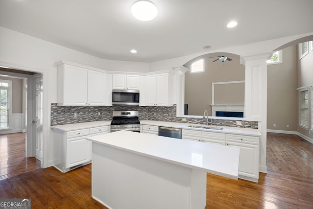 1382 Benbrooke Ln NW, Acworth, GA 30101 - kitchen featuring stainless steel appliances, ornate columns, arched walkways, and recessed lighting