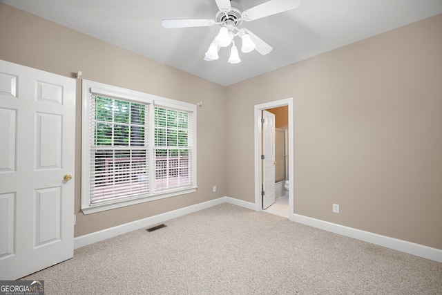 unfurnished room featuring baseboards, visible vents, light carpet, and ceiling fan