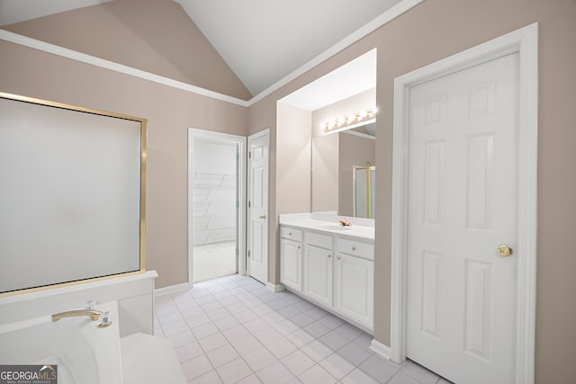 full bath with a walk in closet, tile patterned floors, baseboards, vanity, and lofted ceiling